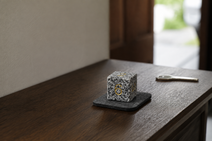Makabe Stone Master Die on a protective pad on an entryway console.