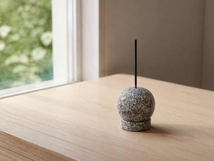 Makabe Stone Incense Stone resting on a clear morning tabletop in soft window light.