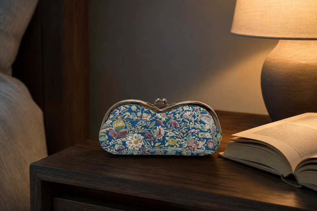 Turquoise Edo Sarasa eyeglass case beside a notebook and pen on a calm indoor desk.