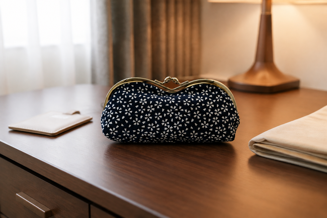 Navy Tokyo Some-Komon eyeglass case on a tidy indoor hotel-room desk.