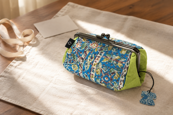 Turquoise Edo Sarasa silk pouch presented alone on linen beside a blank gift note.