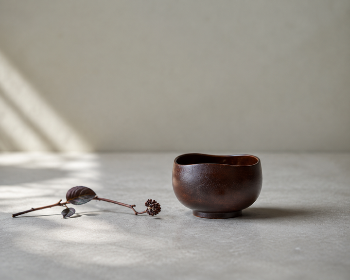 Bud: Lilac lacquerware vessel with one restrained flower stem placed nearby.