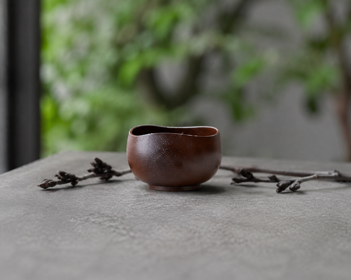 Bud: Lilac lacquerware vessel on a stable shaded terrace table away from direct sun.