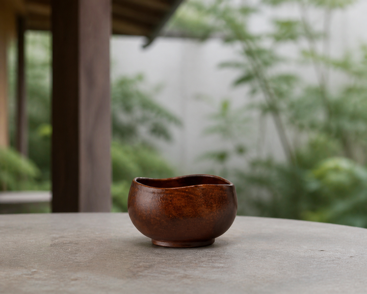 Bud: Mimosa lacquer vessel displayed briefly on a dry shaded terrace surface.