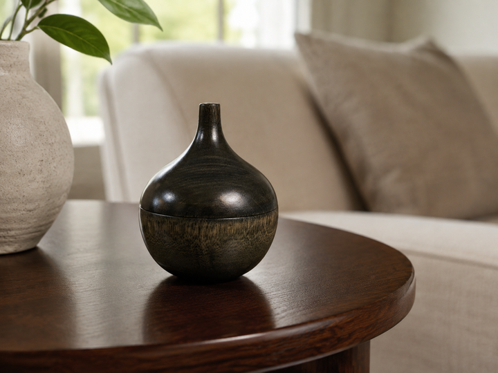 Bulb: Sesame shown closed as a compact bulb-like form on a refined interior table.