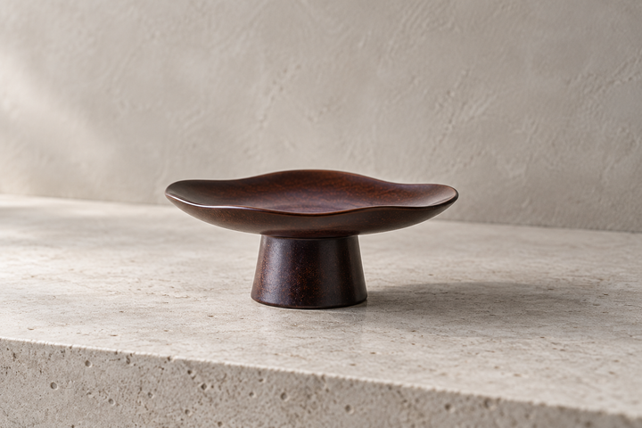 The empty Floating Leaf Lilac dish displayed on pale stone against a plain light wall.
