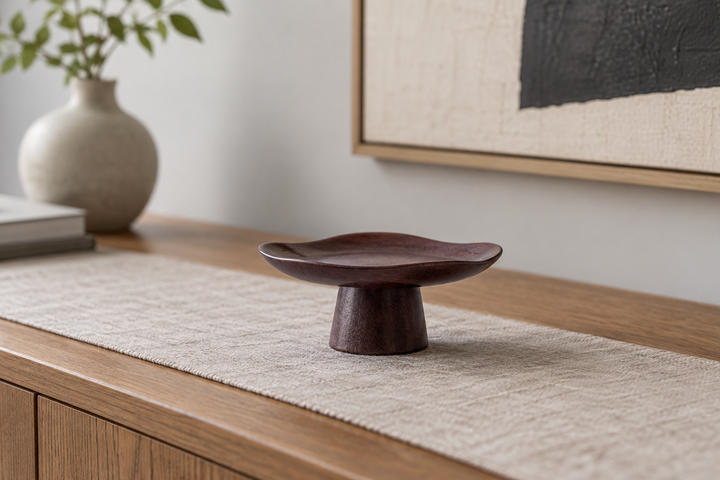 The empty Floating Leaf Lilac dish on a neutral runner over a wooden console beneath artwork.