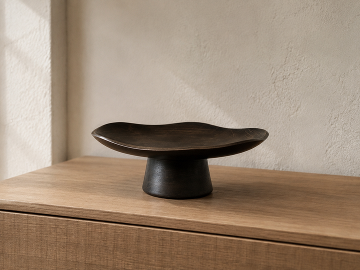 Floating Leaf Sesame displayed empty on a quiet low cabinet with its sculptural silhouette fully visible.