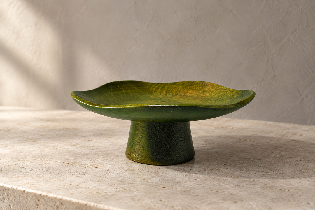 The empty Floating Leaf Olive dish displayed on pale stone against a plain light wall.