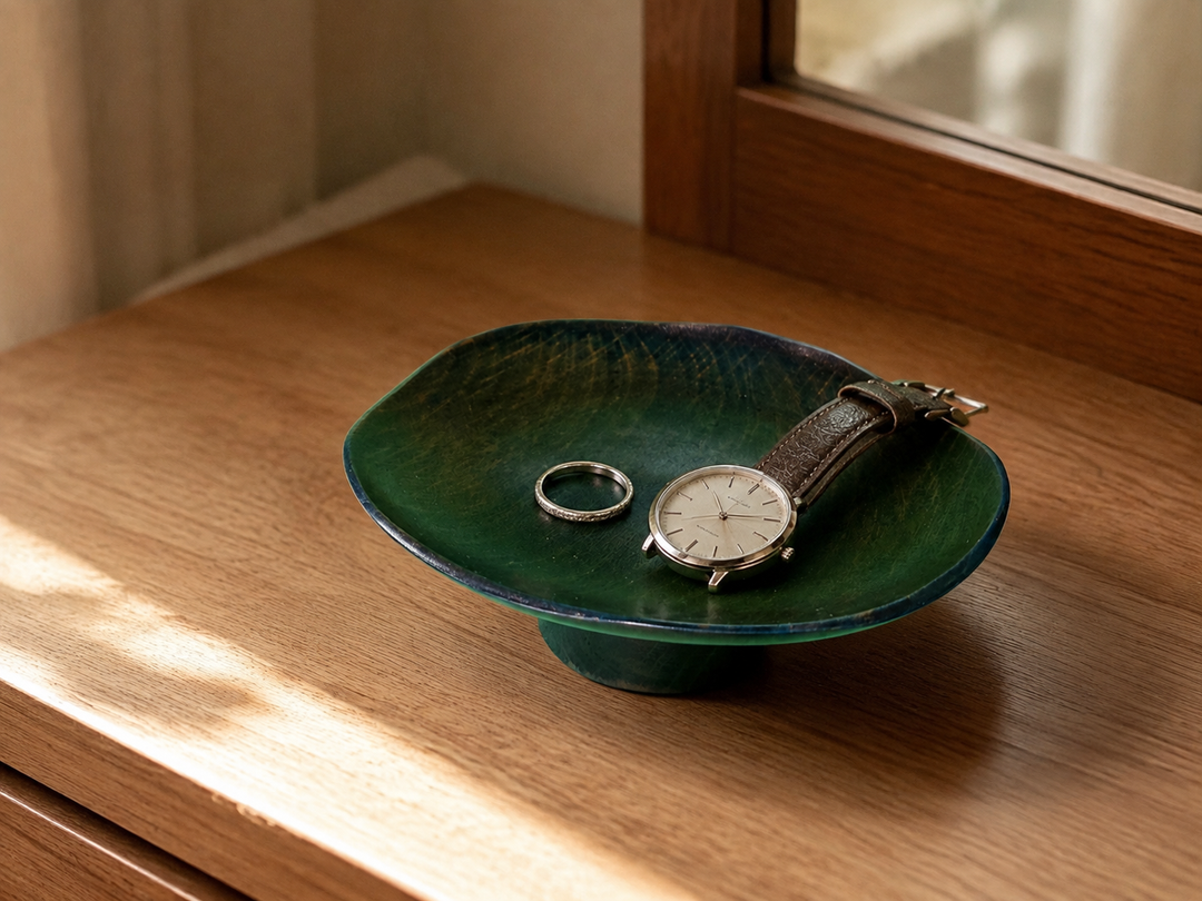 Floating Leaf Hyacinth resting a ring and wristwatch on a quiet bedside table.