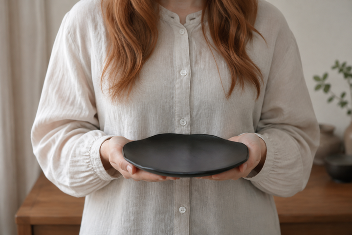 An adult holding the empty RIN 7.0 Sesame level in both hands to show its 210-millimeter scale.