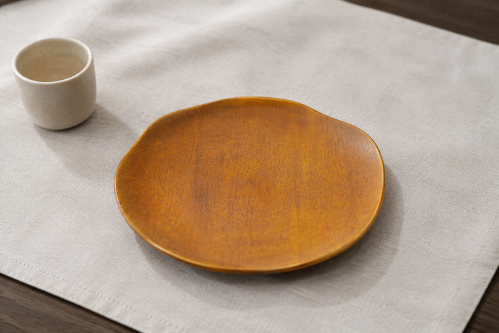 Mimosa-toned RIN 7.0 lacquerware plate displayed empty at a calm individual place setting.