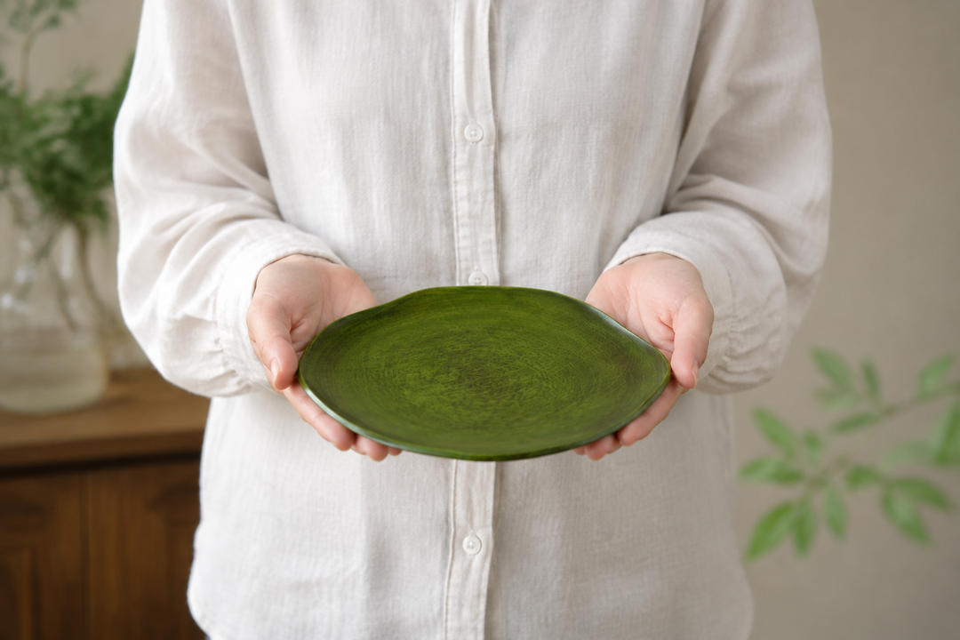 An adult supporting the empty RIN 7.0 Olive level in both hands to show its 210-millimeter scale.