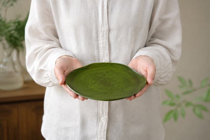 An adult supporting the empty RIN 7.0 Olive level in both hands to show its 210-millimeter scale.