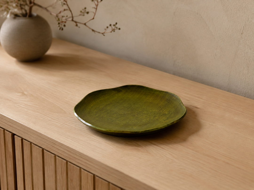 Empty RIN 7.0 Olive displayed indoors on a sideboard with its softly irregular outline visible from above.