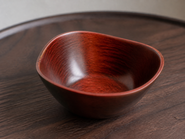 Close view of the empty RIN Bowl M Berry showing lacquer highlights and wood grain across its curved wall.