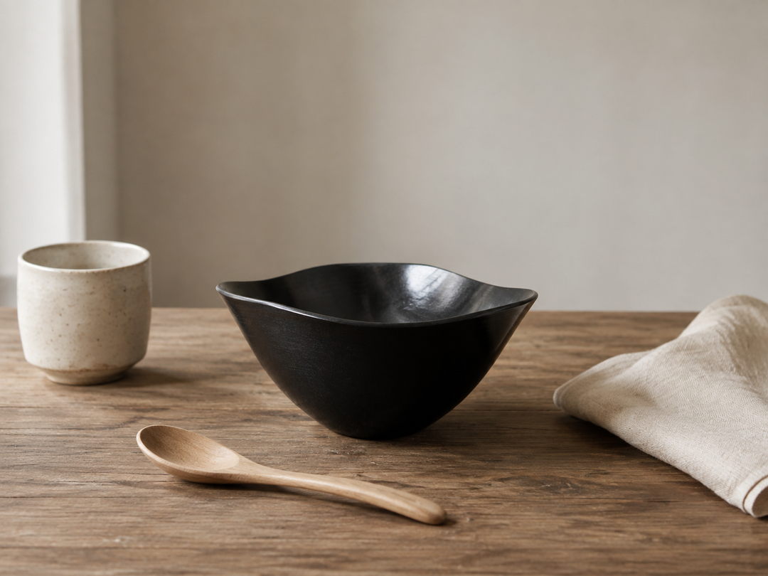 RIN Bowl M Sesame in a quiet room-temperature tabletop arrangement with a cup, wooden spoon, and folded napkin.