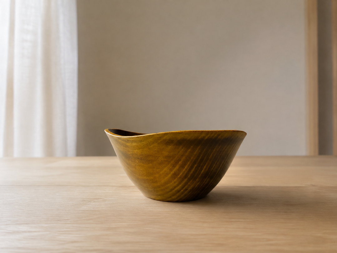 Empty RIN Bowl M Mimosa resting on a stable pale-wood table with its gently rising rim shown in profile.
