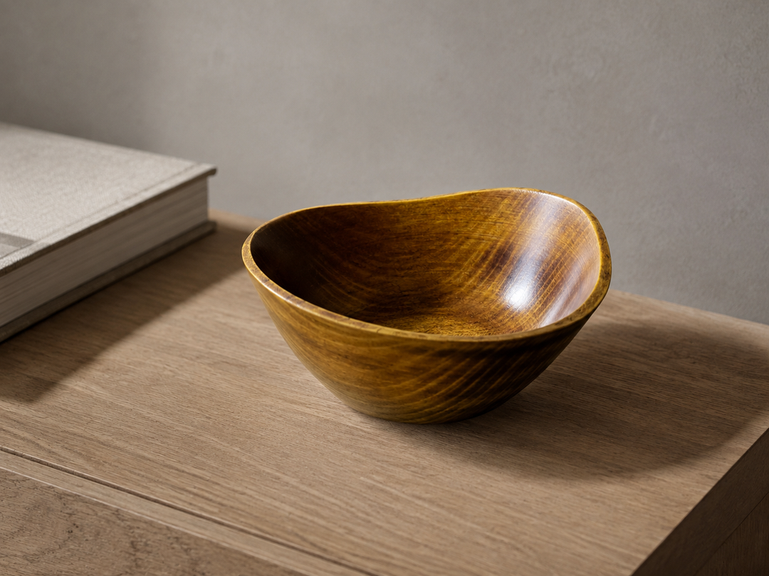 Empty RIN Bowl M Mimosa displayed on a dry indoor side table, viewed slightly from above to show its rim and interior grain.