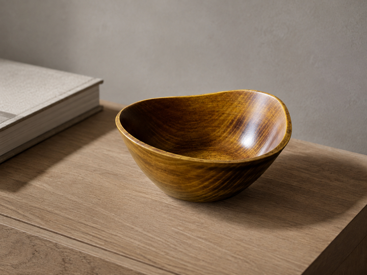Empty RIN Bowl M Mimosa displayed on a dry indoor side table, viewed slightly from above to show its rim and interior grain.