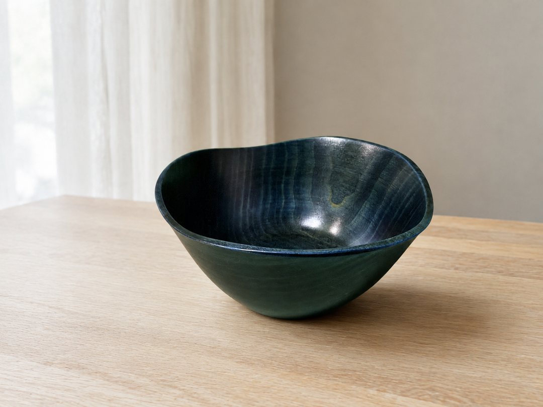 Empty RIN Bowl M Hyacinth resting on a stable pale-wood table with its softly irregular rim shown in profile.