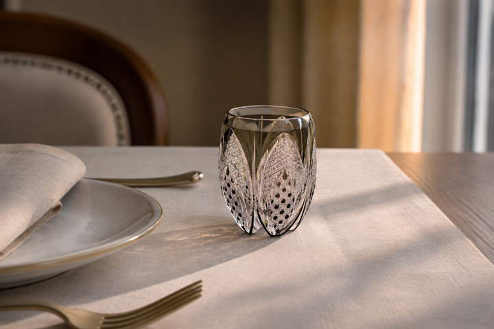 Korohana Blue Ink Edo Kiriko vessel set as a singular accent at a restrained guest place setting.