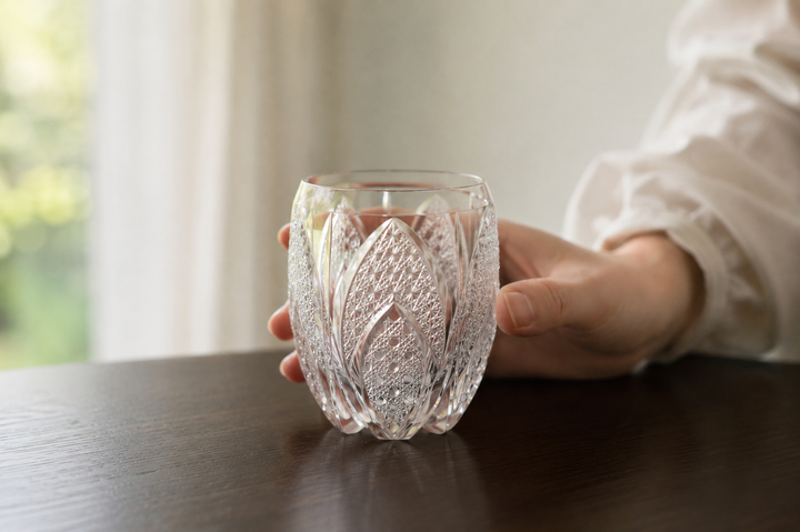 SHIROHANA: Clear being turned gently on a stable surface as natural light moves through its cut pattern.