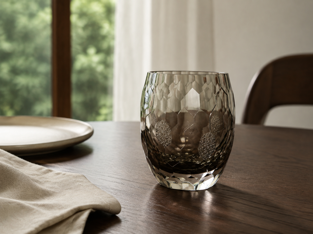 HYOUSYOU Blue Ink Edo Kiriko glass as the single focal point in a restrained pale-linen table setting.