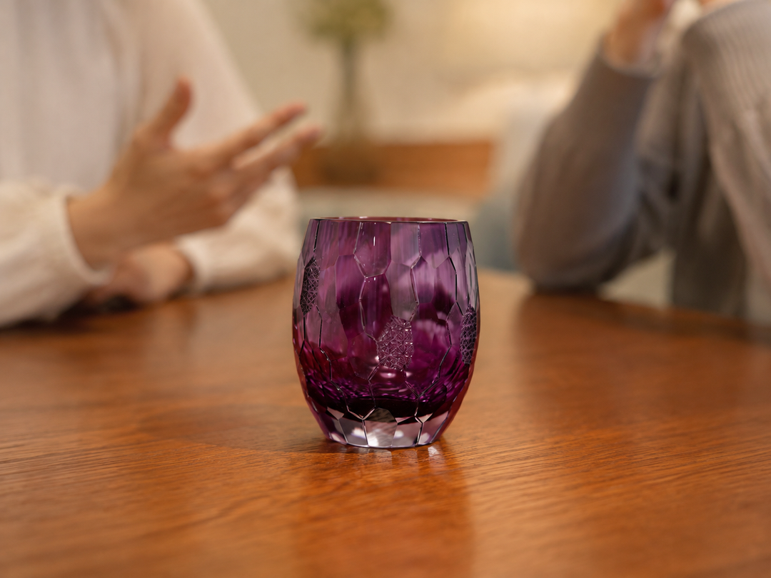 Purple Edo Kiriko glass as the focal point of a restrained table shared by two guests.
