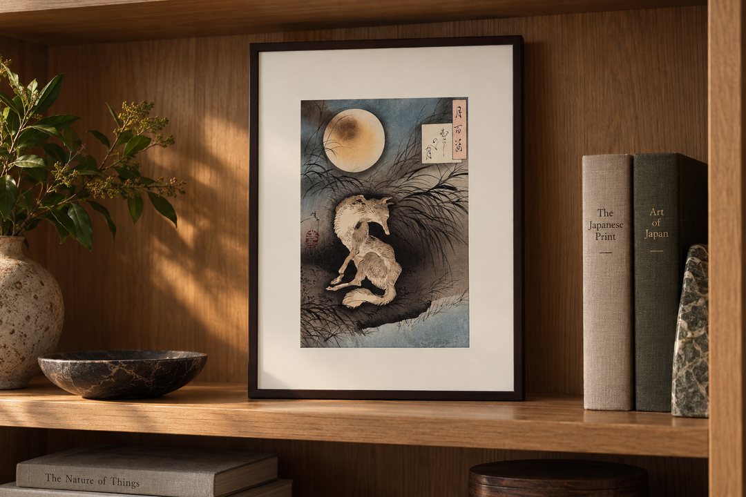 Moon at Musashino Plain displayed upright on a wooden bookshelf beside books, a bowl, and a vase.