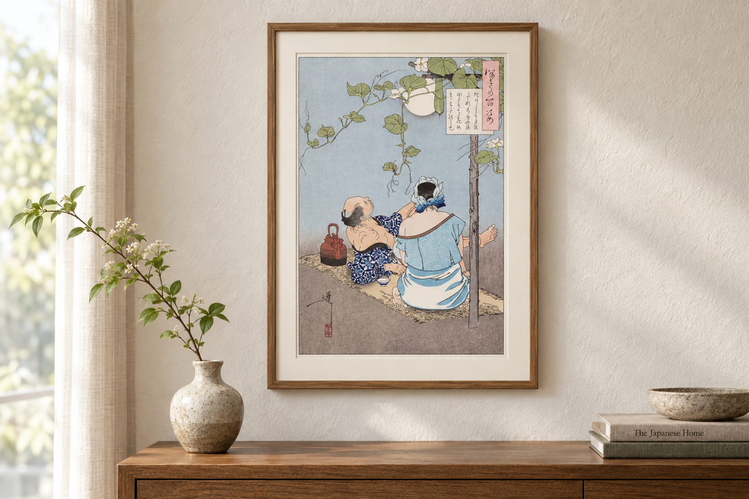 The framed Yoshitoshi summer evening print above a wooden cabinet beside a small vase, books, and a bowl.