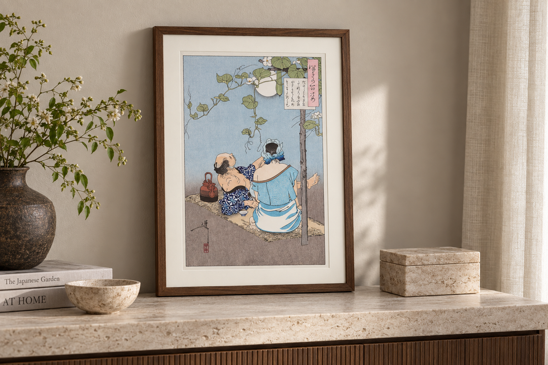 The framed Yoshitoshi summer evening print displayed on a pale stone console with a vase, books, a bowl, and a stone box.
