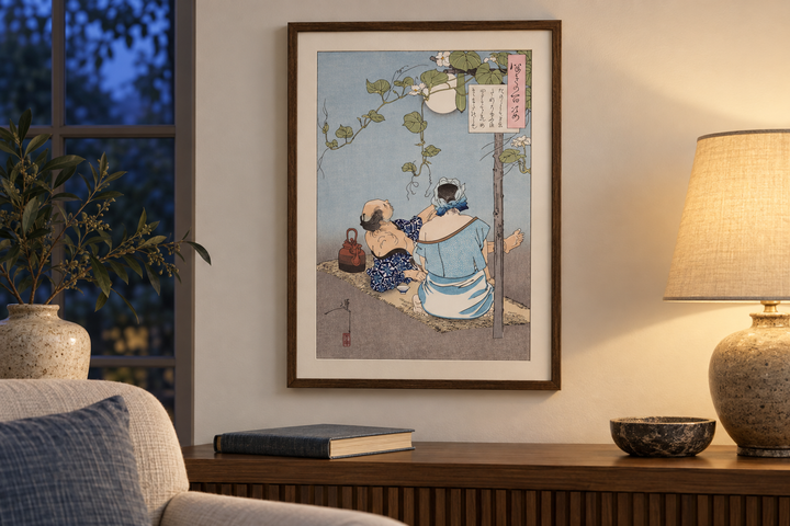 The framed Yoshitoshi summer evening print beside a reading chair and a lit table lamp, with a book and bowl below.