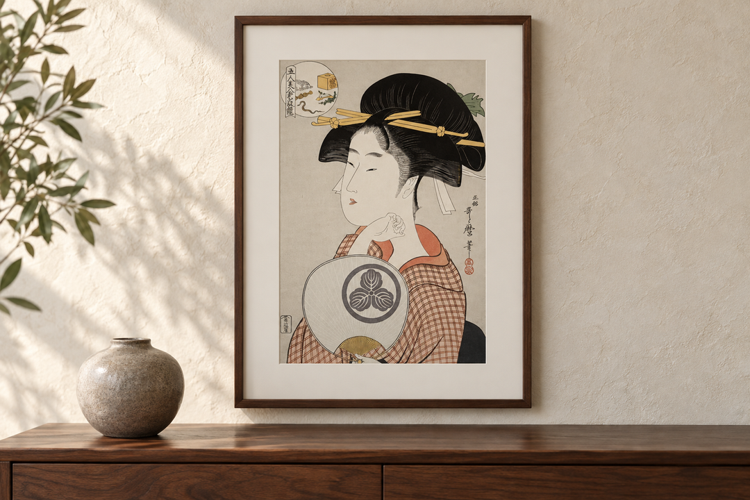 Tomimoto Itsutomi displayed above a wooden cabinet with a rounded vase against a pale wall.