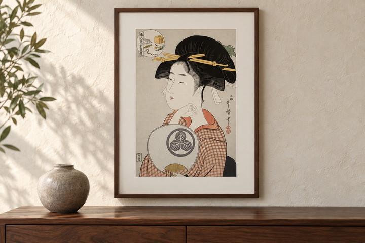 Tomimoto Itsutomi displayed above a wooden cabinet with a rounded vase against a pale wall.