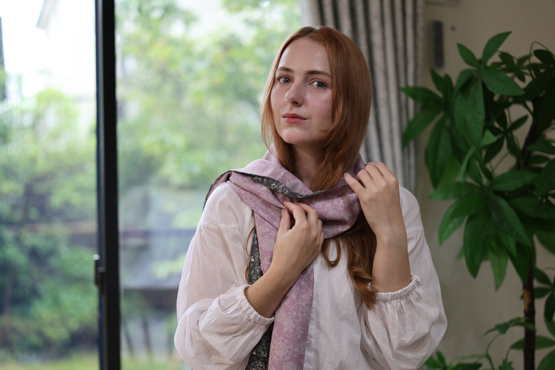 Model wearing the pale purple side of the double-sided sumo-pattern silk stole indoors