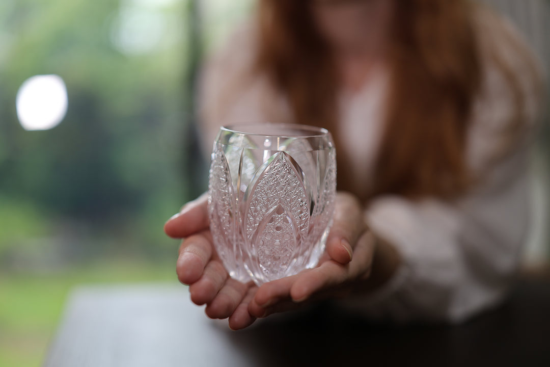 Adult model presenting SHIROHANA: Clear on an open hand near a window, with its cut pattern in focus.