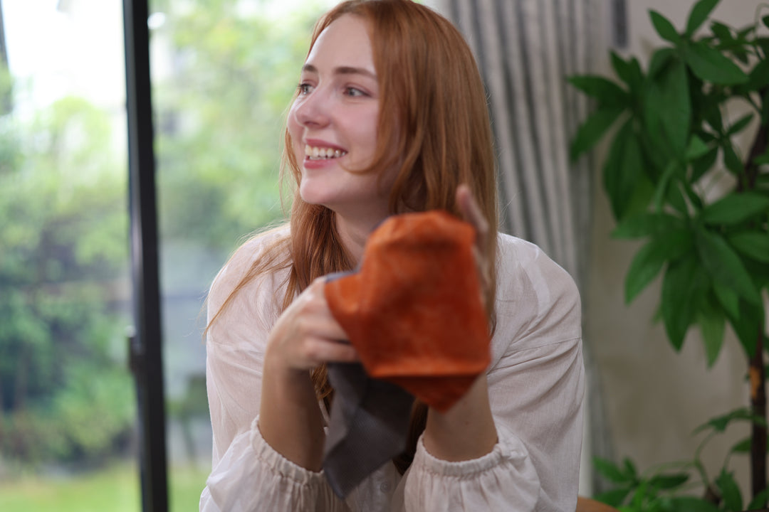 The model holds the orange and brown Tokyo Some-Komon pocket square in a bright interior.