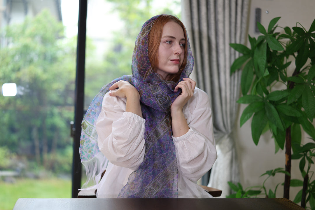 The purple double-woven silk stole arranged lightly over the head and around the neck.