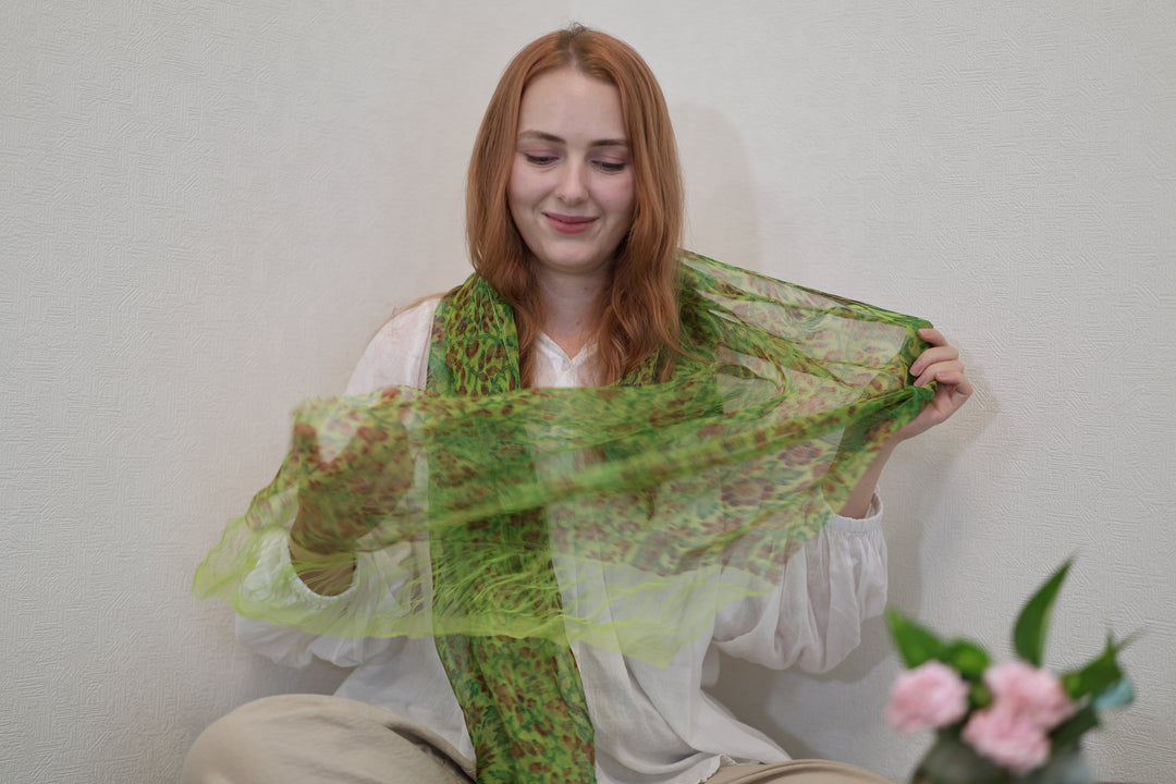The green double-woven silk stole held open to show its translucence and fringe