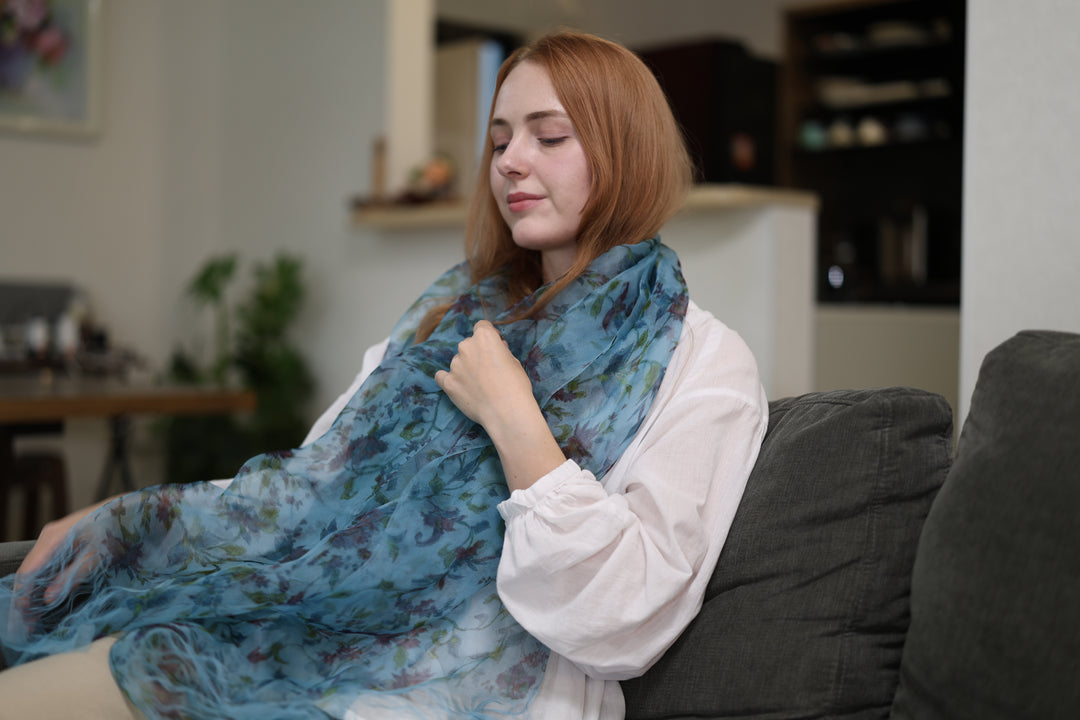 A seated wearer with the blue silk stole spread broadly across the shoulders and lap.
