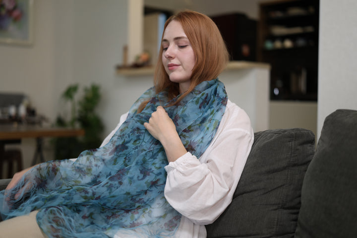 A seated wearer with the blue silk stole spread broadly across the shoulders and lap.