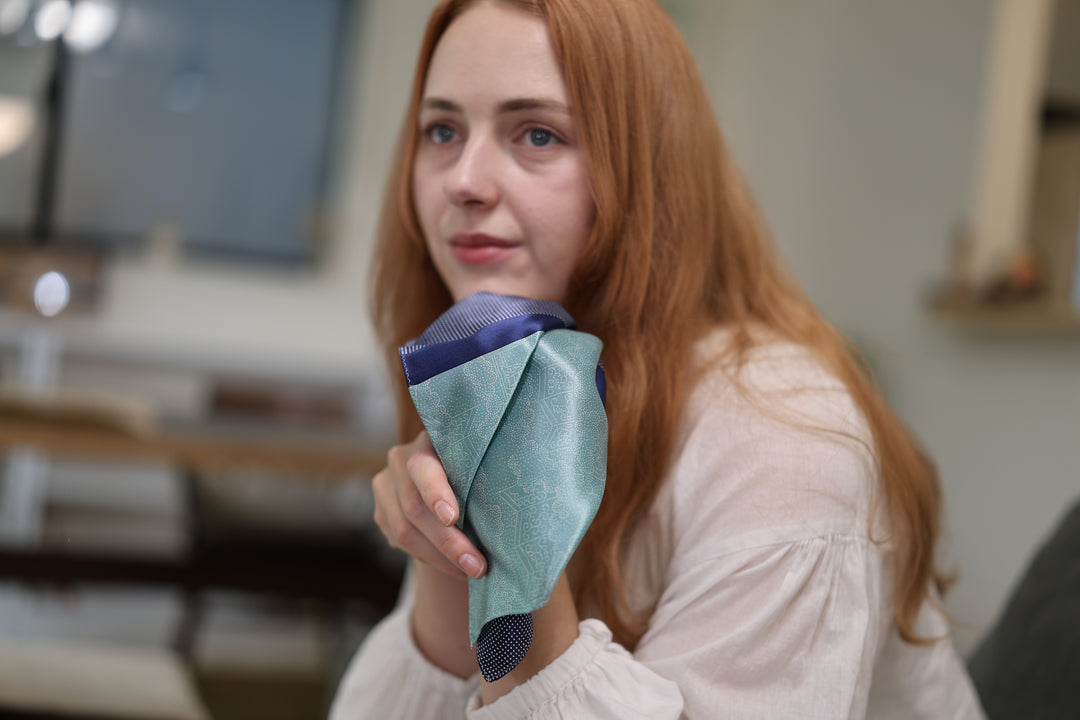 Model presenting the folded Tokyo Some-Komon pocket square at close conversational distance.